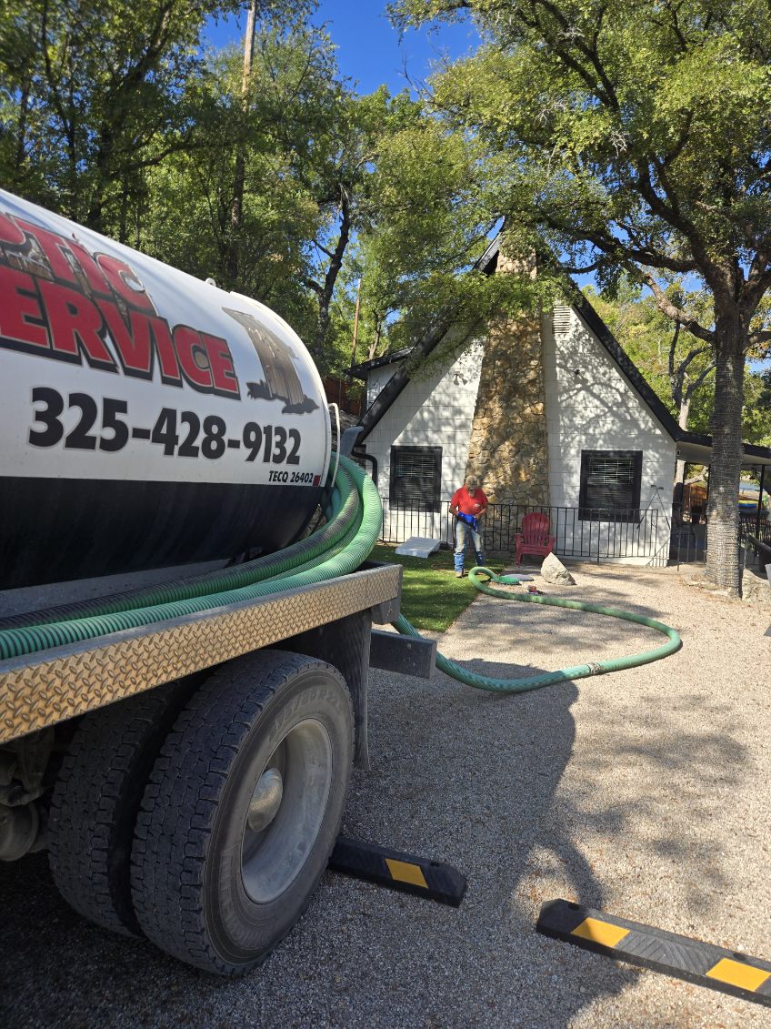 Jackson's truck and technician servicing a home septic system