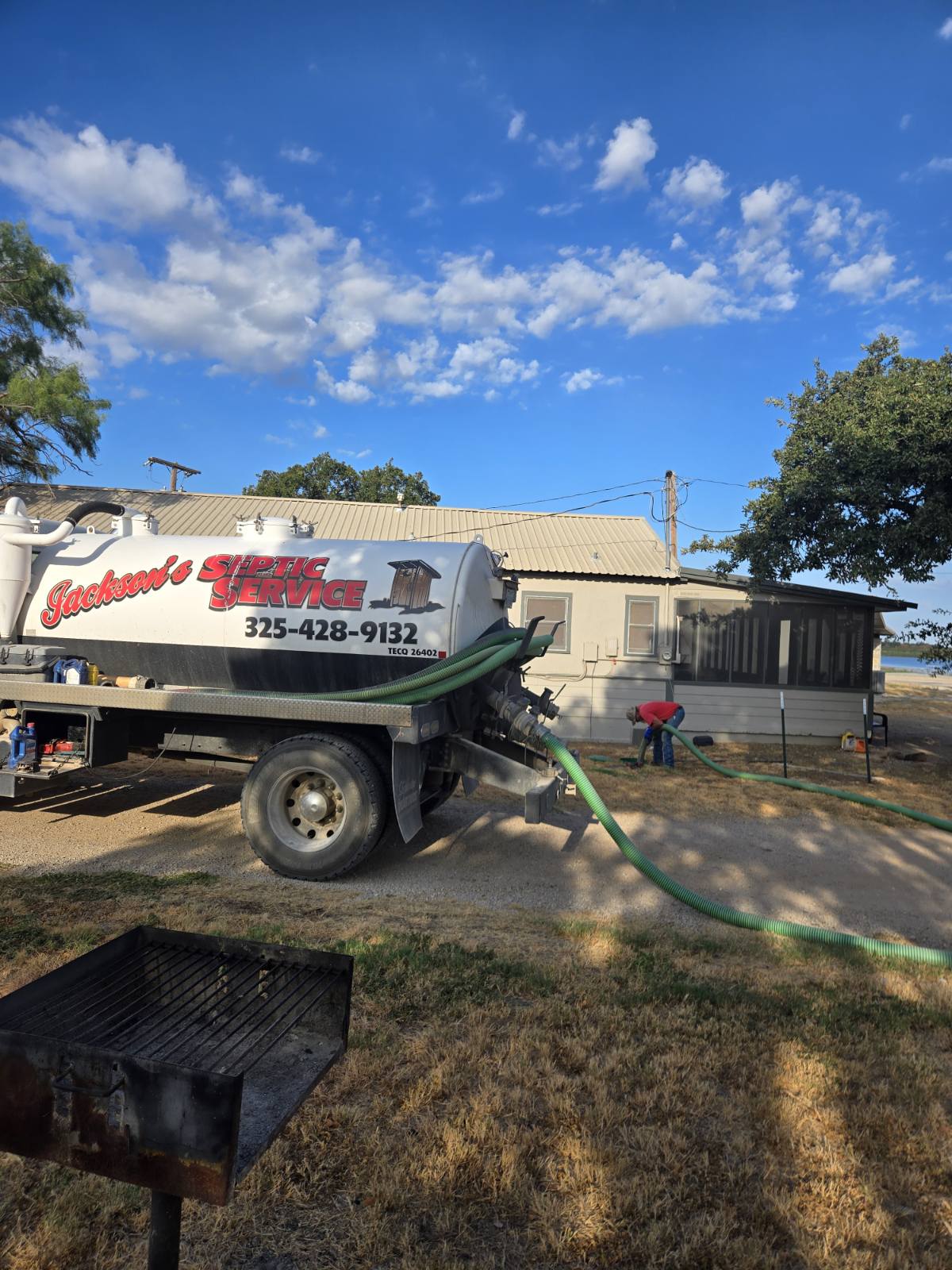 Jackson's Septic Service truck parked beside a home during a pump-out