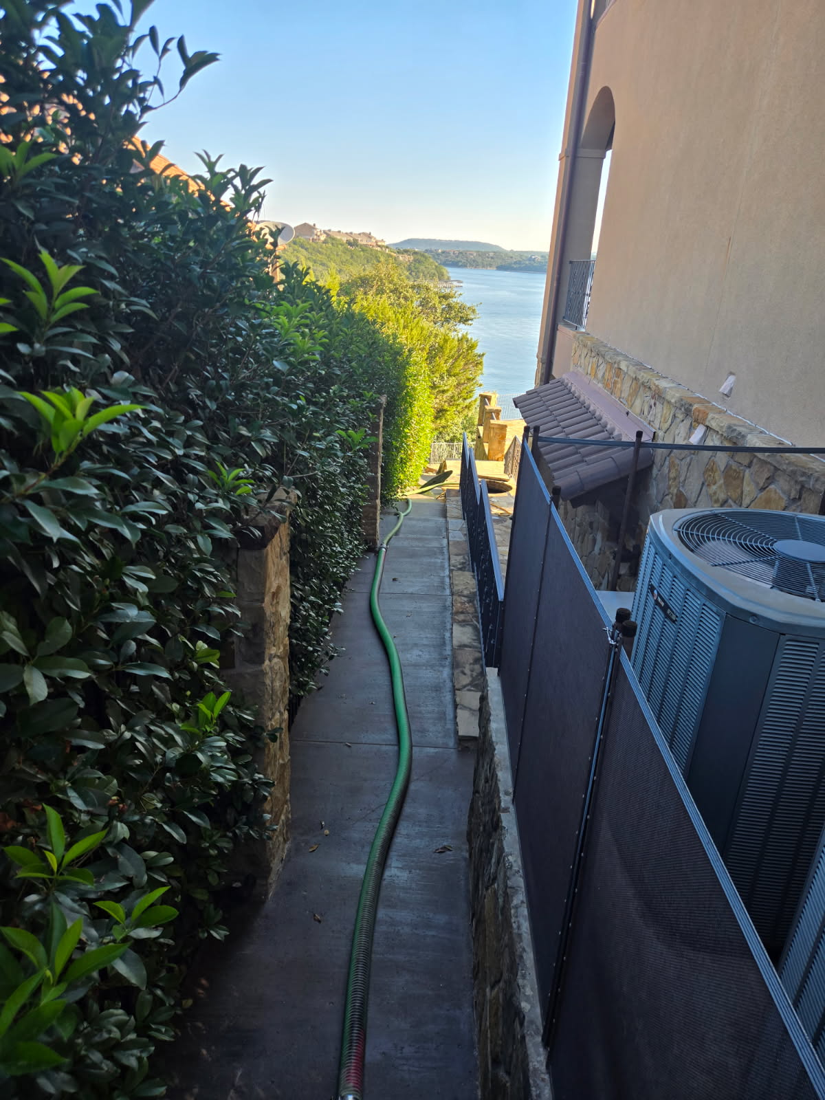 Service hose along a walkway at a residential property